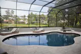 Remodeled freeform pool and spa surrounded by glass fiber reinforced concrete (GFRC) walls with integrated custom aluminum lights. Screen enclosure with mansard roof.
Photo by Vania Hardtle