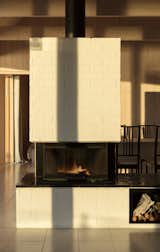 Living Room, Two-Sided Fireplace, and Wood Burning Fireplace Central brick-clad fireplace.  Photo 9 of 17 in Hus Nilsson by Tina Bergman