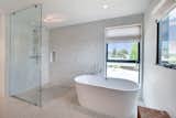 Bath Room Details throughout the house, including the kitchen and bathrooms, reinforce the natural simple design concept and open to select views.  Photo 6 of 11 in Flower Avenue Residence by Cathy Bachl