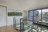 The staircase provides views to the indoor/outdoor spaces below and beyond and lets in natural light.