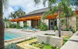Outdoor, Back Yard, Trees, Flowers, Planters Patio, Porch, Deck, Gardens, Swimming Pools, Tubs, Shower, and Walkways Stone site walls extend into the guest house and anchor the building to the site.   Photo 2 of 9 in Luala‘i by Cathy Bachl