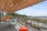 Decks on each living level span width of house. New Ipe cable railing and cedar ceiling.