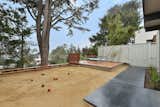 Expanded and renovated rear yard with deck, bocce court and featuring giant Monterrey Cypress