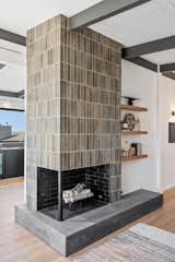 Restored corner fireplace with new tile and concrete hearth