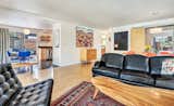 A loft-like, open floor plan with lots of light makes the space feel much bigger. White walls showcase a continually rotating art collection.