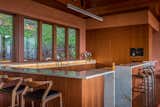 The open kitchen has storage and appliances below the counter, or hidden behind Sapele mahogany wall panels.