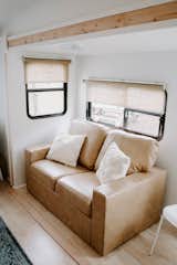 This amazing love seat has storage underneath the seat cushions! Isn't that genius? Especially in a trailer!