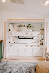 Kids, Bedroom, Storage, Bunks, Toddler, Pre-Teen, Light Hardwood, Neutral, and Rug To maximize space, they added bunk beds to an area that was previously a slide-out entertainment center, and also included storage underneath. 

  Kids Bunks Toddler Bedroom Pre-Teen Photos from The Cougar