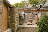 Outdoor and Gardens The kitchen, the property's only modern addition, has been created from a garden courtyard. The space has been enclosed by a glazed roof and wall with sliding door, yet it retains its open feel.  Photos from A Revamped Estate in the English Countryside Asks $2.3M