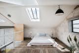 The floor-level bed makes best use of the space in the mezzanine-level bedroom. Luxury additions include recessed Crittall windows and two large skylights,  which bring light streaming into the space.