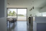 Dining Room, Bar, Concrete Floor, Recessed Lighting, Stools, Table, Chair, and Pendant Lighting A mix of Scandinavian and industrial furnishing add interest to the streamlined kitchen.  Photo 3 of 11 in A UK Home With Panoramic Ocean Vistas Asks $3.5M