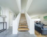 The open hallway and staircase increase the flow of light and feeling of airiness.&nbsp;