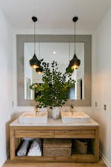 Bath Room, Marble Counter, Medium Hardwood Floor, Ceiling Lighting, and Wood Counter  Photo 4 of 8 in The Sharp Home by Serenbe 