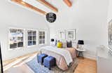 Bedroom, Dresser, Bed, Lamps, Ceiling Lighting, Chair, Medium Hardwood Floor, Night Stands, and Table Lighting  Photo 15 of 20 in Mado Modern Farmhouse by Serenbe 