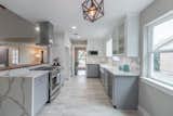 Accent Lighting, White Cabinet, Range, Engineered Quartz Counter, Undermount Sink, Ceramic Tile Floor, Marble Backsplashe, Recessed Lighting, and Ceiling Lighting  Photo 4 of 10 in The Wigton House by Ivan Garcia