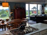 View over the kitchen workspace into the dining and living rooms with the pacific ocean beyond