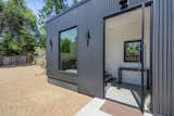 A last minute change was the use of Metal Sales corrugated metal in matte black for the entry and the window wall.  A 4’ wide Western Windows pivot door adds a bit of excitement to the entry.
