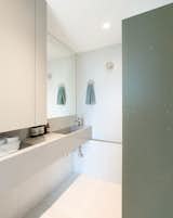 Bathroom cocooned in soothing hues of oat and verde