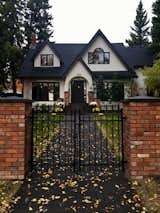 Front of house with reused brick on fence columns 