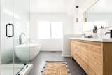 Bath Room, Engineered Quartz Counter, Freestanding Tub, Undermount Sink, Enclosed Shower, Ceramic Tile Wall, Pendant Lighting, and Porcelain Tile Floor Warm wood tones updates the bright, white palette in the main suite.  Photo 8 of 11 in Ladera Heights Midcentury Love by Samira Mahjoub Tapia