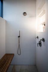 Situated on a gently sloping narrow lot in Kirkland, WA, large windows and an open floor plan fill this contemporary brick home with light, creating a seamless connection to the outdoors. The design uses the site topography to its advantage - sunken gardens, terraced greenery, and other intimate covered outdoor spaces are created for gathering or quiet reflection in the serene, modern landscaping, while the house above projects toward sweeping panoramic views of Lake Washington.