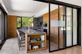 This new home nestles amongst the trees of a watershed to take advantage of smaller moments of privacy in an otherwise urban environment. Mid-century lines divide airy interior volumes anchored by a concrete garage. Using screens and sliding doors to create spaces that can transform based upon need.