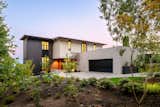 This new home nestles amongst the trees of a watershed to take advantage of smaller moments of privacy in an otherwise urban environment. Mid-century lines divide airy interior volumes anchored by a concrete garage. Using screens and sliding doors to create spaces that can transform based upon need.