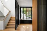 This new home nestles amongst the trees of a watershed to take advantage of smaller moments of privacy in an otherwise urban environment. Mid-century lines divide airy interior volumes anchored by a concrete garage. Using screens and sliding doors to create spaces that can transform based upon need.