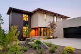This new home nestles amongst the trees of a watershed to take advantage of smaller moments of privacy in an otherwise urban environment. Mid-century lines divide airy interior volumes anchored by a concrete garage. Using screens and sliding doors to create spaces that can transform based upon need.
