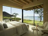 The bedrooms are designed with corner windows, providing stunning wrap-around views of the coastline. 