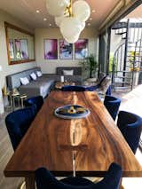 The living room, terrace, and dining area flow together. Sliding glass doors open to the terrace, connecting indoor and outdoor living space.