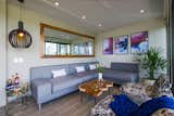 The living room features a custom-designed sectional that turns into two single beds to accommodate additional guests.