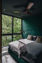 Sahara Jade master bedroom with floor-to-ceiling windows facing the jungle