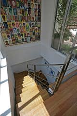 Open riser stair fit within an existing large closet off main hall of this Chelsea (NYC) loft. Large painting at main stair wall is by client/owner Thom Heyer (artist/ theatrical costume designer).
