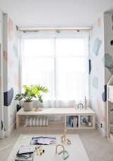DIY WINDOW SEAT: Under a windowsill, EKET cubes are used to create a structure and storage for a DIY window seat.