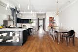An industrial gourmet kitchen is open to the dining room.
