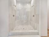 Master bath double shower features custom stonework