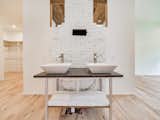 Master bath double vanity connects to 1920s cabin fireplace, custom stonework, wood from original cabin.