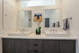 custom built mid century style double vanity. notice transom window above sinks brink in natural light