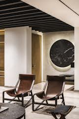 Living Room, Travertine Floor, and Chair At the main access, a bold and striking marble element decorates the space  Photos from Apartment in Ahuehuetes Norte