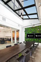 The boardroom features a 14 ft long sustainably sourced slab table, which sits under a massive skylight.  Sit under the "open sky" as you have your board meetings and meet with clients.  A green wall at the front of the room underscores our interest in designing work environments that focus on health and well-being in the workplace.  