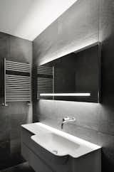 ‘Linear’ – The sink console with the large mirror and the tower warmer.