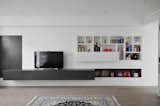 Living Room, Sofa, Bookcase, End Tables, Coffee Tables, Accent Lighting, Recessed Lighting, Ceiling Lighting, Medium Hardwood Floor, and Console Tables The TV wall bespoke inset-furniture  Photo 3 of 16 in Terraced House in Fulham - Open LDK by Daniele Petteno Architecture Workshop