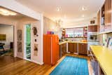 Sleek, modern cherry kitchen gives a retro look with extra amenities.