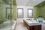 Japanese soaking tub and teak double sink vanity for a spa worthy experience.