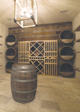 Is a lake house ever truly complete without its own wine cellar and barrel tasting room? Of course not. Here, the owners can cellar bottles in a perfectly temperature-controlled environment, waiting for that Chateau Margaux to hit the perfect maturity, or just hosting an intimate evening of tasting with friends. If temperature changes fall outside a safe range, the Control4 system notifies them immediately, so not a single drop is lost.