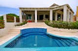 Backyard porch and a small piano shaped pool overlooking the beautiful blue Cancun Bay