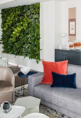 Hallway and Medium Hardwood Floor Our clients are lovers of environment, so we designed a living plant wall, adjacent to the foyer, for an entryway full of original art pieces and vibrant plant life.  Photo 2 of 17 in Central Park West Penthouse by Decor Aid