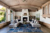 Great Room with concrete floors & radiant heat, grey-washed redwood ceiling and trim, enormous fireplace, and bi-fold doors to the garden