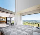 The master bedroom ceiling is 13 feet high and tilted to 29 degrees. When opened, the homeowners are able to sleep in the open air. Their request to the architect was that they be able to stargaze before falling asleep.